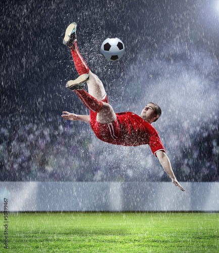 Photo: football player striking the ball football player striking the ball