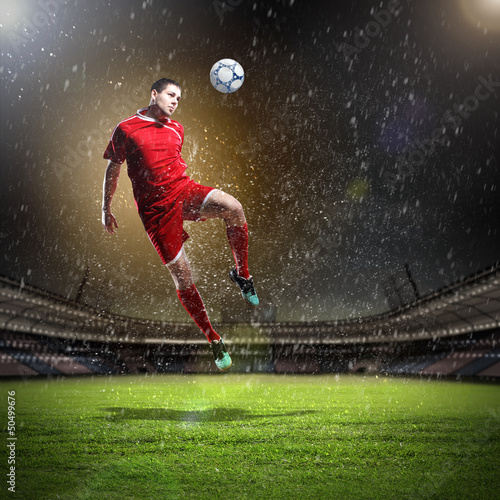 Photo: football player striking the ball football player striking the ball
