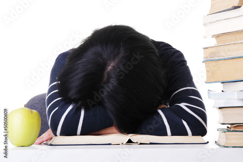 Photo: Young woman sleeping on desk Young woman sleeping on desk