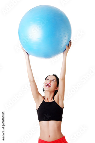 Photo: Woman with pilates exercise ball. Woman with pilates exercise ball.