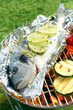 Gilthead breem roasting over a barbecue