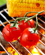 Cherry tomatoes grilling over a fire