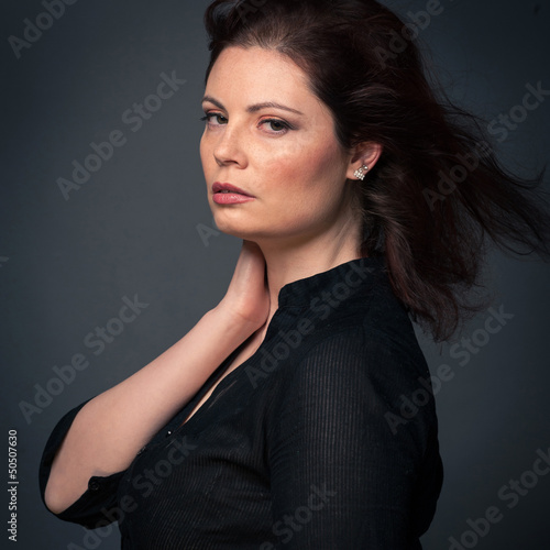 Photo: Sensual red head woman close up portrait on dark background. Sensual red head woman close up portrait on dark background.