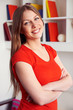 woman posing over bookshelf