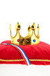 Golden crown on velvet pillow with Dutch flag