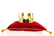 Golden crown on velvet pillow