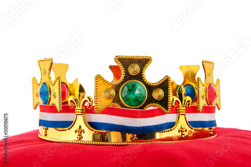 Photo: Golden crown on velvet pillow with Dutch flag Golden crown on velvet pillow with Dutch flag