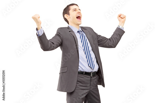 Photo: Young businessman gesturing excitement with raised hands Young businessman gesturing excitement with raised hands