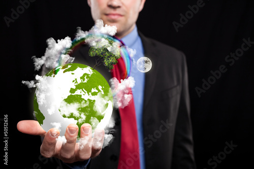 Photo: Businessman holding the world in his hand Businessman holding the world in his hand