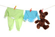Baby clothes hanging on clothesline, isolated on white