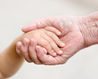 hands of young child and old senior