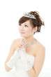Beautiful asian woman dressed as a bride on white background