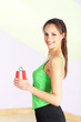 Young woman with carpal expander at gym