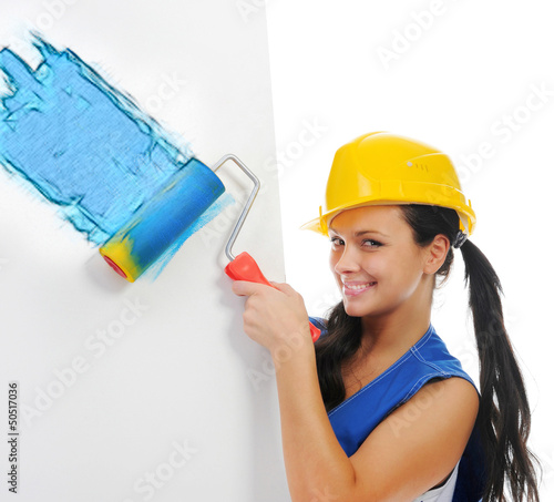 Photo: Beautiful young woman doing repairs Beautiful young woman doing repairs