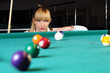 Young girl playing snooker