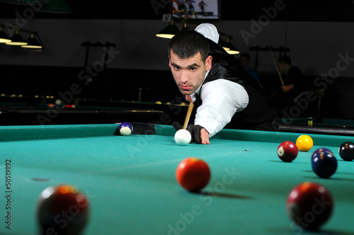 Photo: person playing snooker in a club person playing snooker in a club