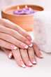 beautiful manicure with aromatic candles and towel. Spa
