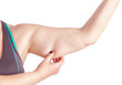 Middle-aged woman holding a hand with excess fat. On a white bac