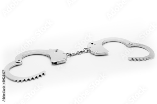 Photo: Metal Handcuffs isolated Metal Handcuffs isolated