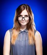 Disappointed young girl looking through the nerd glasses