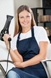 Female Hairdresser Holding Hairdryer