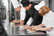 Chefs Garnishing Dishes On Counter