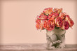 A bouquet of vintage roses decorated by old fabric