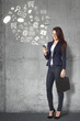 Beautiful businesswoman browsing internet with smartphone