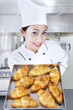 Photo: Chef holding croissants in kitchen Chef holding croissants in kitchen