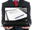 Businessman holding an open laptop