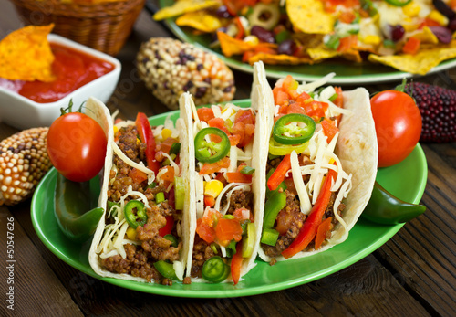 Photo: Beef taco on the plate with vegetables Beef taco on the plate with vegetables