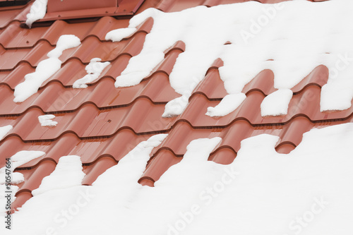 Photo: Snow melting on a red roof Snow melting on a red roof