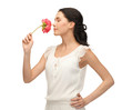 young and beautiful woman smelling flower