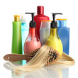 comb brush with hair and cosmetic bottles, isolated on white