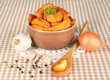 Appetizing village potatoes in bowl on beige tablecloth