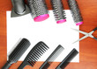 Comb brushes, hairdryer and cutting shears,on wooden background