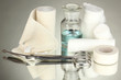 First aid kit for bandaging on grey background