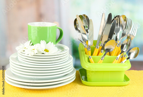 Photo: Plates, forks, knives, spoons and other kitchen utensil Plates, forks, knives, spoons and other kitchen utensil