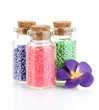 Little bottles full with colorful beads isolated on white