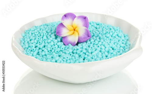 Photo: Colorful beads with handmade flower in plate isolated on white Colorful beads with handmade flower in plate isolated on white