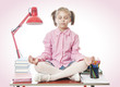 Photo: Schoolgirl meditating on the desk Schoolgirl meditating on the desk
