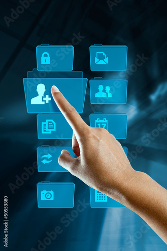 Photo: a finger of a woman, selects and opens a folder a finger of a woman, selects and opens a folder
