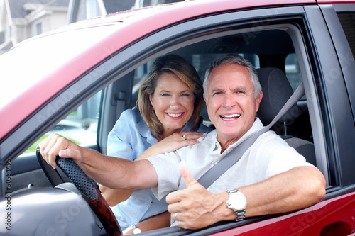 Photo: Happy senior couple in the car. Happy senior couple in the car.