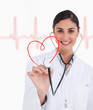 Photo: Happy doctor holding up stethoscope to red heart design Happy doctor holding up stethoscope to red heart design