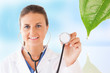 Photo: Doctor holding up stethoscope for natural treatment Doctor holding up stethoscope for natural treatment