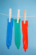 Three condoms hanging on line