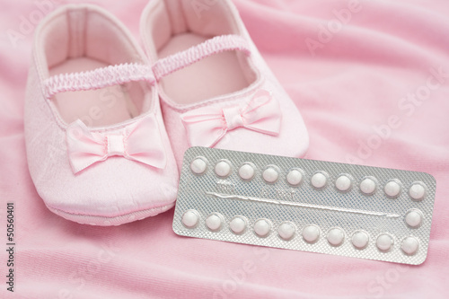 Photo: Contraceptive pill packet with baby booties Contraceptive pill packet with baby booties