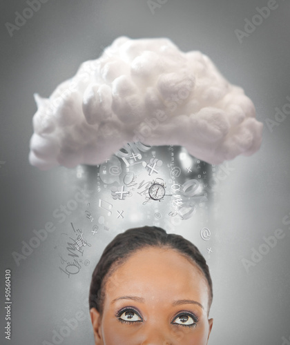 Photo: Girl thinking about cloud computing Girl thinking about cloud computing