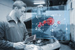 Mechanic using tablet and futuristic interface in black and whit
