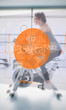 Woman riding exercise bike with futuristic interface next to her